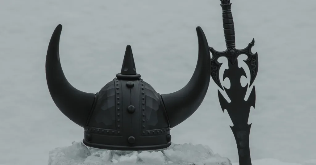 Viking helmet and sword lying in the snow