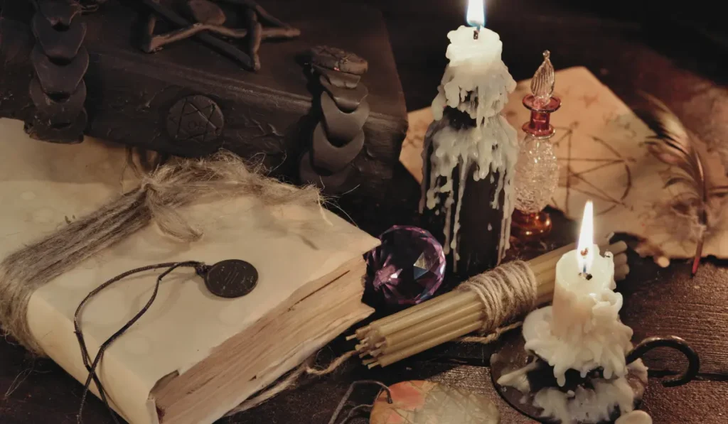 Magickal objects, such as candle, book of shadows, talisman, on an altair