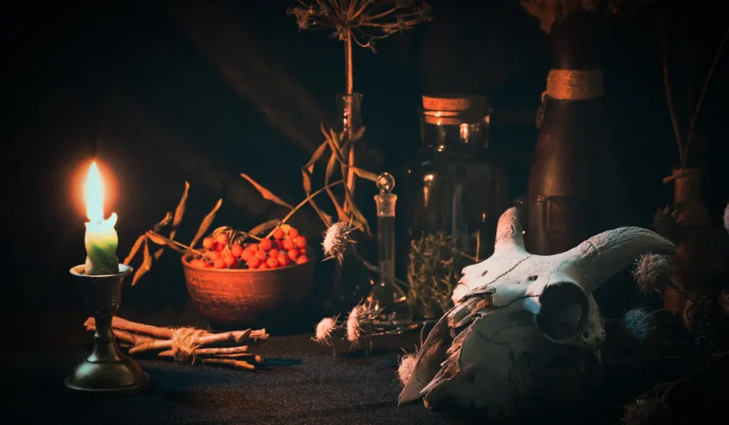 A goat skull displayed among various magical objects, arranged for chaos magick ritual work